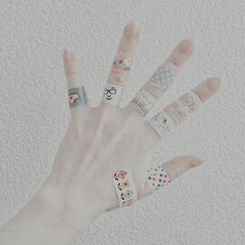 Hand with plasters